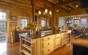 Furness Barn Kitechen with ceiling beams, gridded windows, marble countertops, and large central island in Haverford, PA