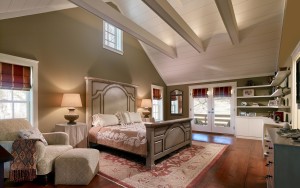Glenn Mills spacious farmhouse style master bedroom loft with glass doors to balcony and ceiling beams in Media, PA