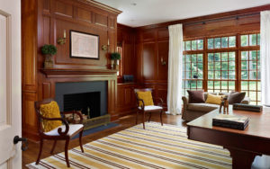 beech road house library with American cherry wood panel walls, grid windows, and traditionally inspired millwork in Bryn Mawr PA