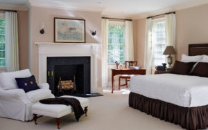 beech road house master bedroom with fireplace and gridded windows in Bryn Mawr, PA