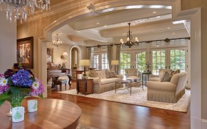 Ardrossan Estate living room with chandeliers, hard wood floors, glass doors, and ceiling beams in Villanova, PA