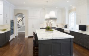 Ashwood Hall Kitchen with central island, marble countertops and hard wood floors in Devon, PA